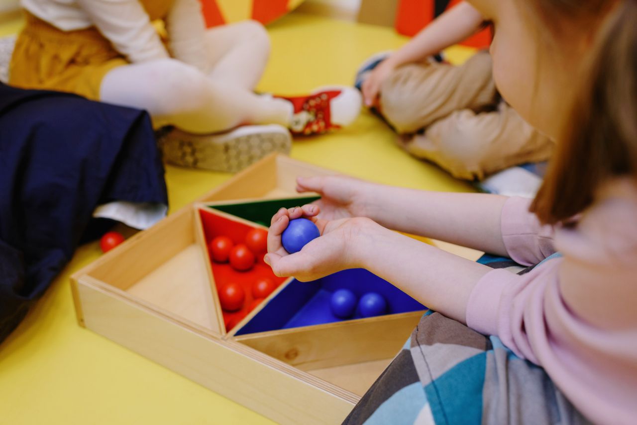 Contact Kids enjoying playtime with educational wooden toys in a friendly environment.