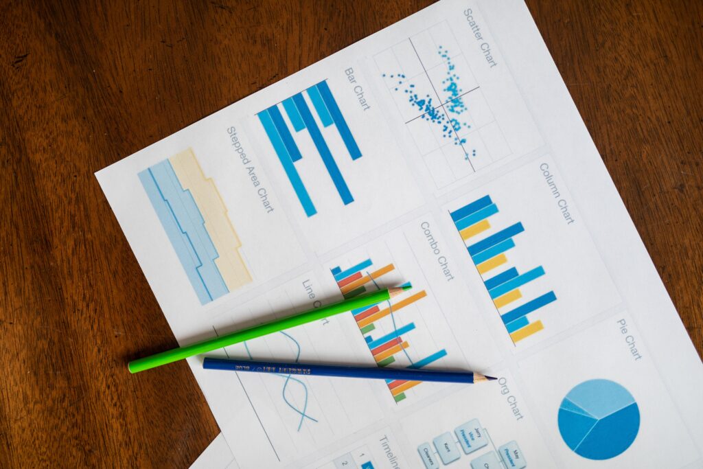 pexels photo 7947844 7947844 Top view of vibrant charts and colored pencils on wooden surface.