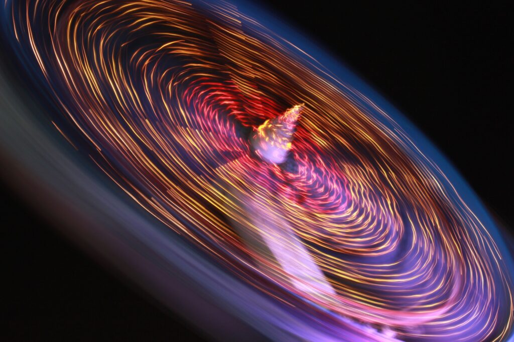 Colorful spinning lights create dynamic movement in this vibrant abstract image.